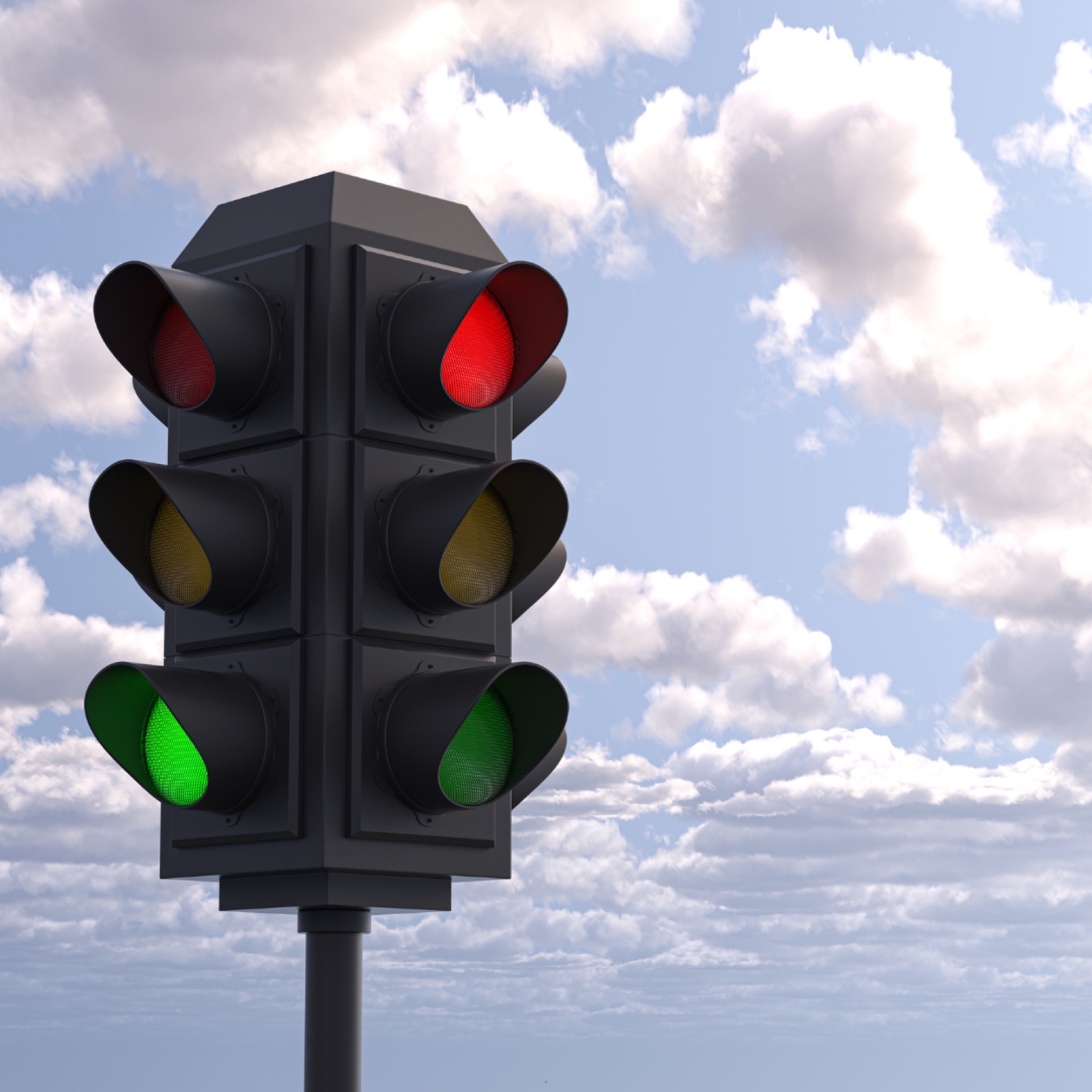 Traffic light with red and green lights on against a cloudy blue sky. The scene is calm and clear, showing an urban setting.